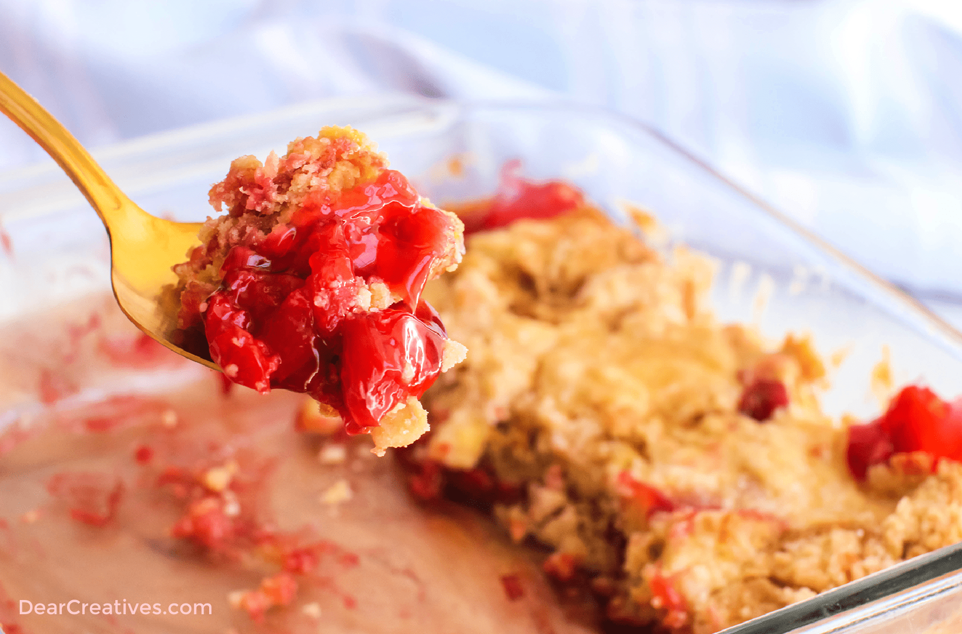 Cherry dump cake in an 8 x 8 pan - Easy to make. Add to dessert cups, ramekins, or bowls and top with whip cream or ice cream. Print the recipe at DearCreatives.com  ©2022 DearCreatives.com Theresa Huse