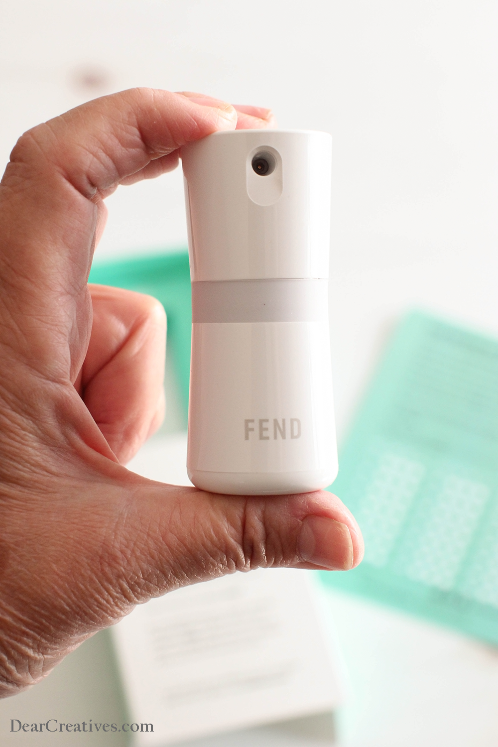 Holding FEND to spray airway solution - FEND product review ©2022 DearCreatives.com