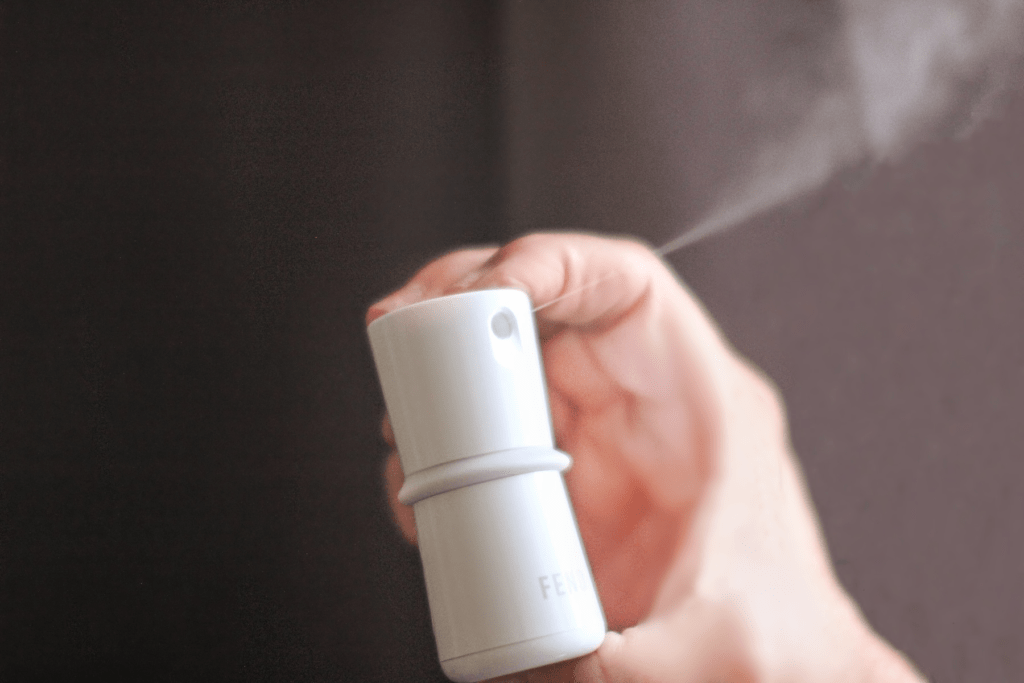 Spraying FEND to inhale the natural mist solution for cleaner breathing. See product review and get a discount at © DearCreatives.com