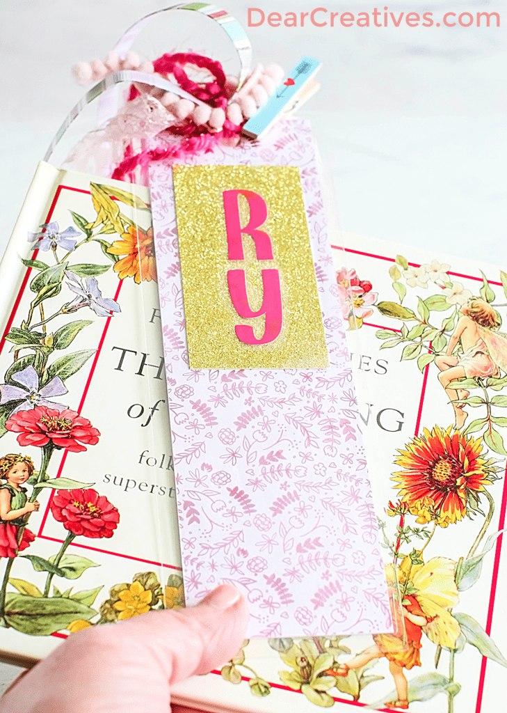 DIY Bookmark Idea - Holding a finished bookmark next to a book ©2023 DearCreatives.com