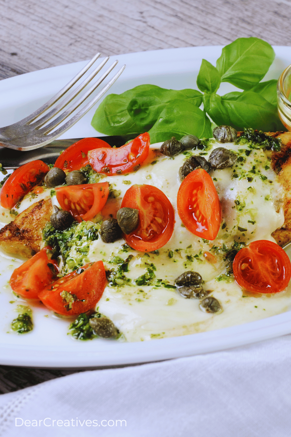 Chicken Mozzarella - Make this recipe with chicken thighs or chicken breasts. Easy, 30 minutes, and one pan! Tasty Mozzarella chicken DearCreatives.com (closeup of Caprese Chicken)