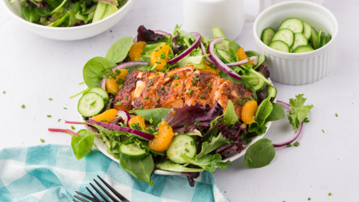Close up of salmon salad with the applewood, orange & ginger salmon on top of the salad and sliced for eating. It is so delicious and healthy! Click over for the recipe at DearCreatives.com