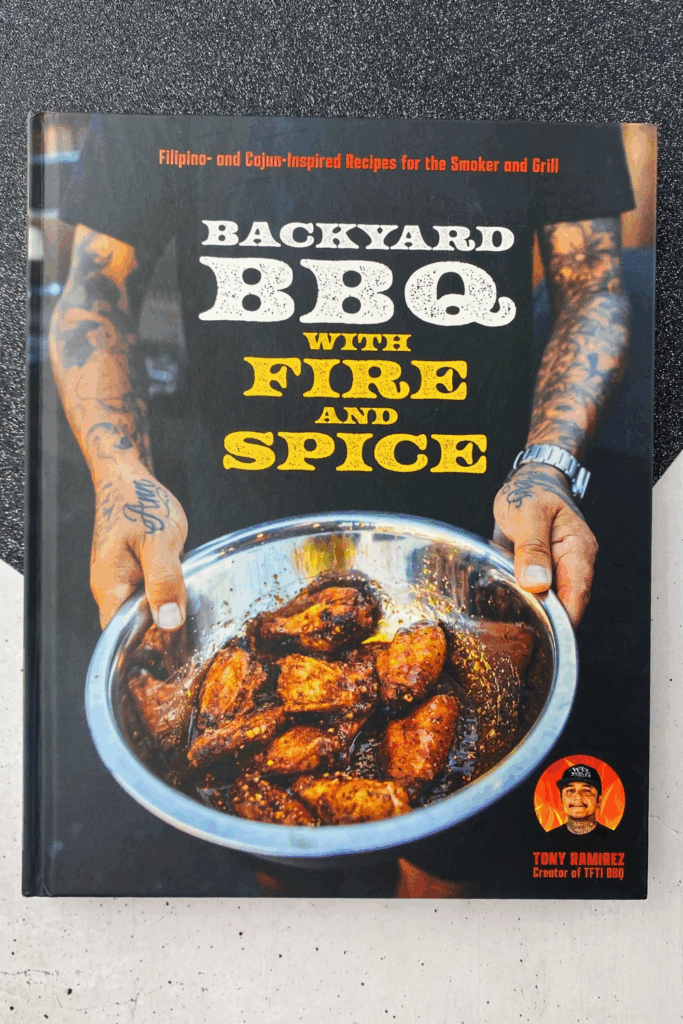Backyard BBQ with Fire and Spice cookbook showing a delicious BBQ chicken in a pan or bowl
