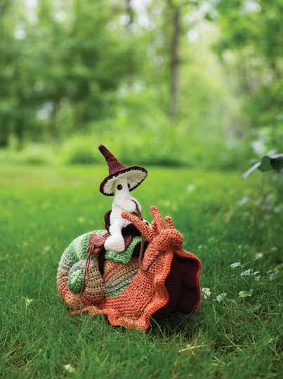 Crochet snail with a mushroom riding on it