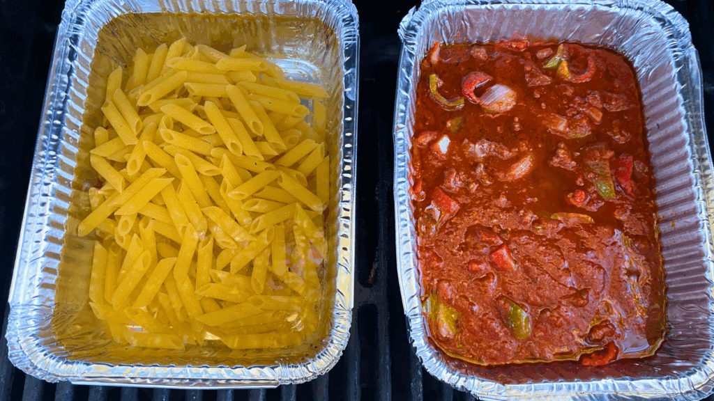 skillet spaghetti on the grill noodles in a boiling pan of water and pasta meat sauce in an aluminum pan