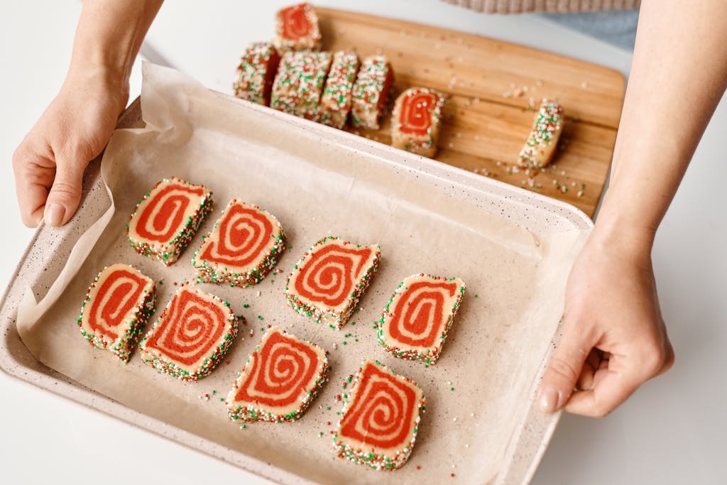 Colorful spiral cookies with sprinkles on a baking tray, perfect for festive occasions, holiday cookies, Christmas cookies easy.