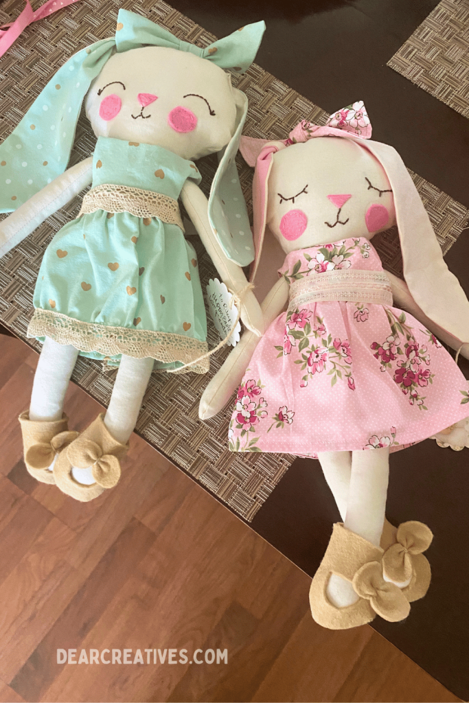 finished fabric bunny dolls from sewing pattern wearing handmade cotton dresses