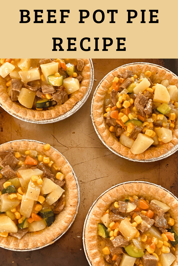 image of beef pot pies on a sheet pan ready to have pastry top added and baked. Text overlay beef pot pie recipe