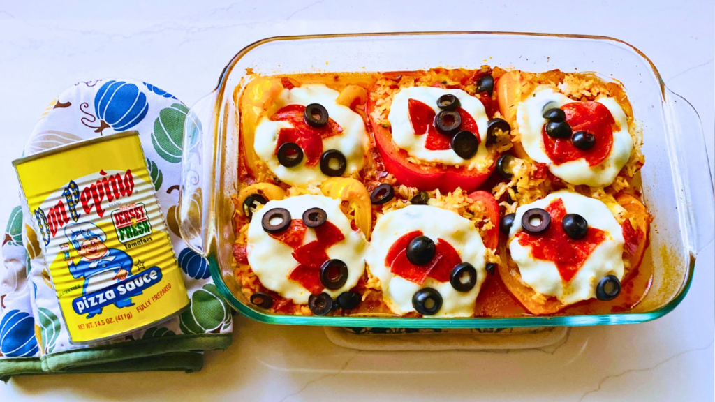 Pizza Stuffed Peppers with rice, Don Pepino Pizza sauce, pepperoni slices, black olives, and mozzarella cheese in a baking dish ready to serve.